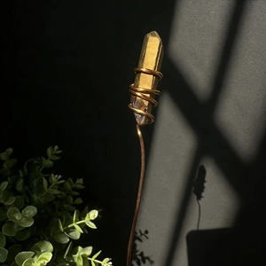 Macro detail of natural yellow crystal wand wrapped in bronze wire for floral decor