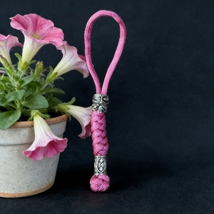 Detail of pink paracord braid with vintage silver viking beads and rune patterns