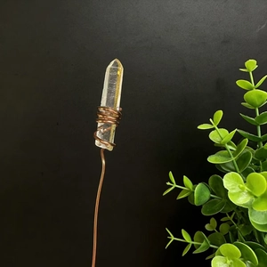 Macro view of natural white crystal column with hand-wrapped copper wire detail