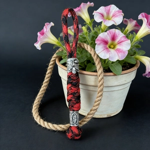 Detail of red and black paracord lanyard with Viking warrior and rune bead accents