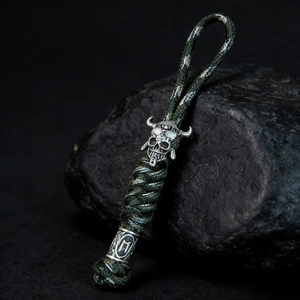 Close-up of paracord lanyard featuring a silver Spartan skull and Runic beads decor