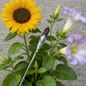 Detail of vintage silver hairpin with hexagonal brown crystal flower insert decor