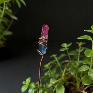 Macro detail of gradient crystal stone wrapped in copper wire for floral arrangement