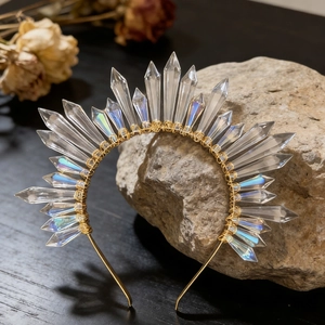 Macro detail of sun goddess crown with crystal quartz stones and gold wire wrapping