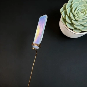 Macro detail of handmade aura quartz crystal wrapped in copper wire for floral decoration