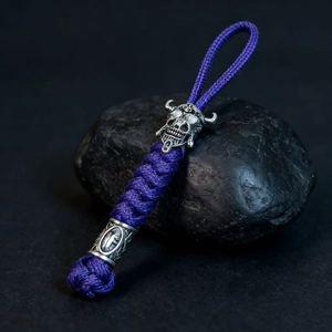 Handmade purple paracord keychain with vintage silver spartan skull bead and embossed metal tube