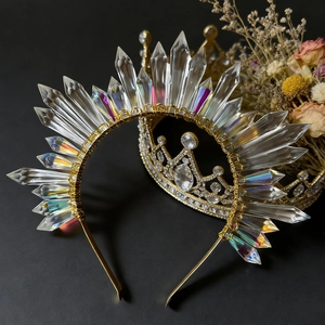 Macro detail of sun goddess crown with iridescent crystal points on golden metal band