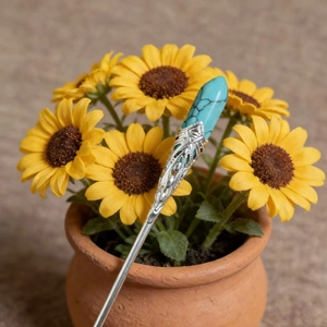 Detail of vintage silver hairpin with turquoise cone stone and hollow filigree work