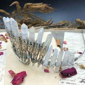 Detail of handmade crystal crown showing white quartz points and moon metal ornament