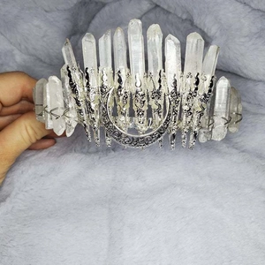 Detail of handmade white crystal crown with a silver crescent moon on a metal headband