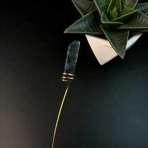 Detail of bohemian gold wire-wrapped natural teal crystal flower arrangement stick