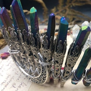 Iridescent crystal crown with silver moon filigree on a vintage background