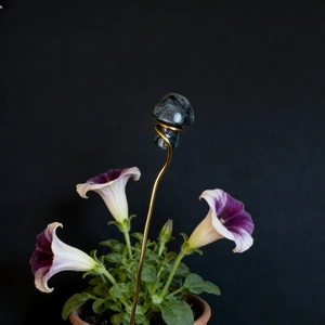 Macro view of Labradorite mushroom plant stake with gold wire wrap in a flower pot