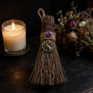 Close-up of wizard broom with purple crystal and antique bronze dragon pendant charm