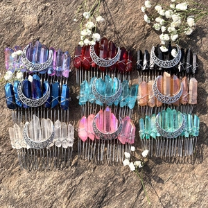 Detailed close-up of handmade wicca moon hair combs with colorful raw crystal stones