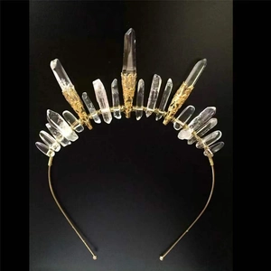 Detailed macro view of natural clear crystal crown with gold wire wrap and vintage carving
