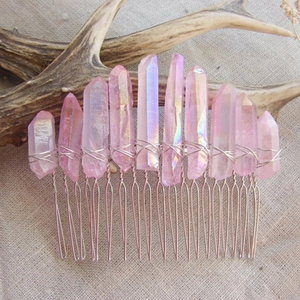 Detail of pink crystal hair comb with silver wire wrapping on rustic linen background