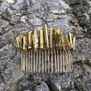 Macro detail of handmade golden raw crystal hair comb with intricate wire wrapping