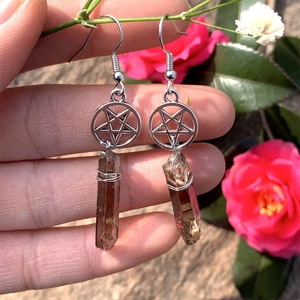 Detail of silver pentagram earring with natural smoky quartz stone and wire-wrapped design