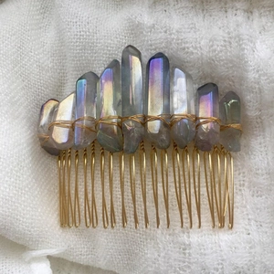 Detail of bohemian aura quartz crystals hand-wrapped with gold wire on a hair comb