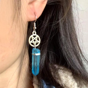 Bohemian silver pentagram earrings with blue crystal prism pendant on model ear