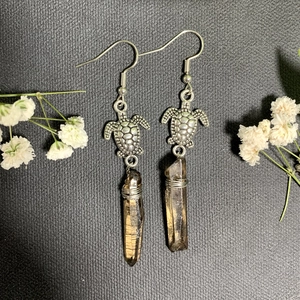 Detail of vintage turtle drop earrings with smoky quartz crystal in bohemian style