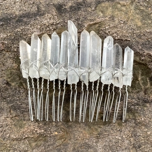 Detailed silver wire-wrapped raw clear quartz crystals on a handmade wicca hair comb