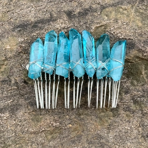 Detailed macro view of seven blue crystals wired to a silver bridal hair comb