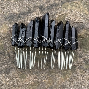 Macro shot of Wicca moon hair comb with black natural stones and silver wire wrap