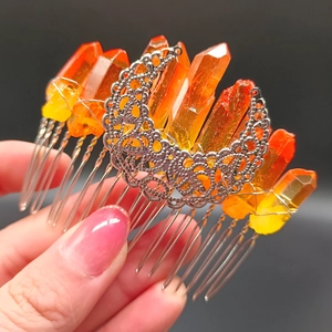 Detailed macro view of crystal moon hair comb with orange quartz stones and silver finish