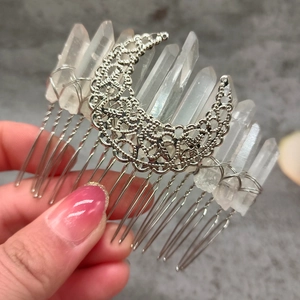 Detailed view of bohemian hair comb with silver moon and natural white crystals