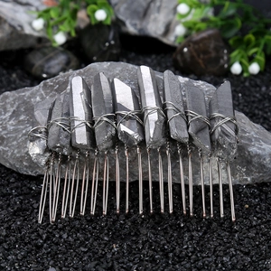 Detailed close-up of handmade Wicca hair comb with silver raw crystals on stone base