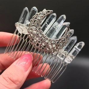 Detailed view of bohemian hair comb with raw clear crystal points and silver moon charm