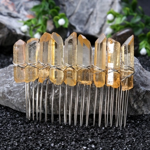 Macro detail of handmade Wicca hair comb with orange crystals and silver wire wrapping