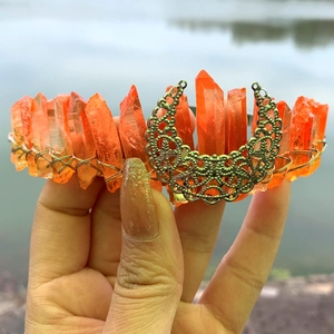 Detail of handmade bohemian crown with orange crystal clusters and crescent moon motif