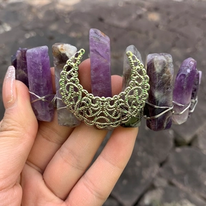 Detail of handmade purple crystal witch crown with silver crescent moon element