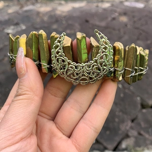 Macro detail of handmade moon crystal crown featuring iridescent gold quartz and silver moon