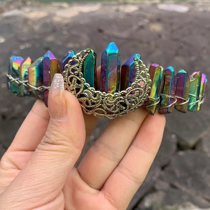 Detailed view of handmade rainbow crystal crown with silver wire-wrapped moon ornament