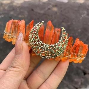 Detail of handmade orange crystal crown with silver crescent moon and wire wrapping