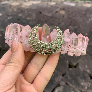 Detail of pink crystal moon crown with silver wire wrapping and intricate moon ornament