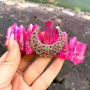 Detail of handmade crystal crown with pink quartz columns and golden moon metal piece