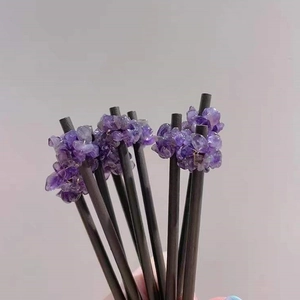 Detail of natural amethyst stone hair pins featuring rustic wrapped crystal clusters