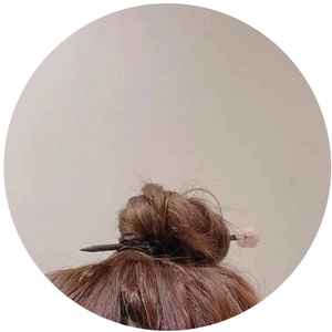 Ancient style hair pin with pink flower and natural amethyst crystals on a brown hair bun
