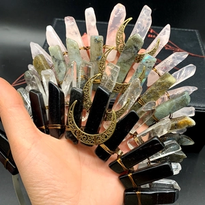Detail of handmade quartz crown featuring labradorite crystals and bronze moon charms