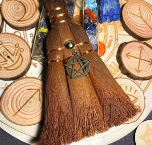 Detail of handcrafted mini wicca altar broom with copper wire and pentagram pendant charm