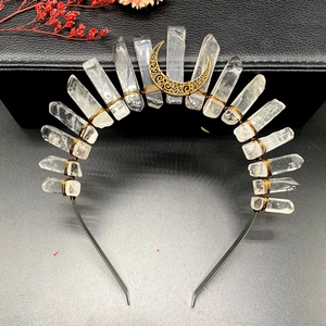 Detail of clear crystal moon crown with bronze wire wrapping on a black metal headband