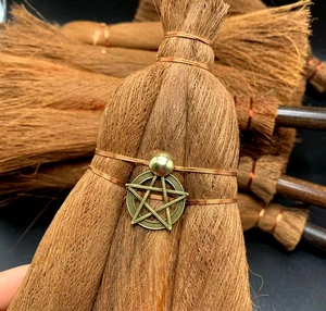 Detail of wicca mini straw broom car charm with bronze pentagram and gold bead