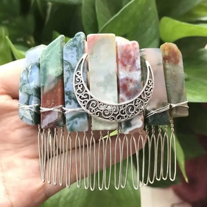 Detailed view of handmade crystal hair comb with moon charm and polished natural stones