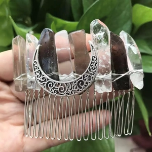Detail view of handcrafted moon crystal hair comb with raw quartz stones and silver wire