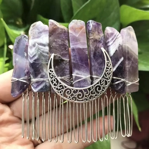 Close-up of handmade purple crystal hair comb with silver crescent moon detail